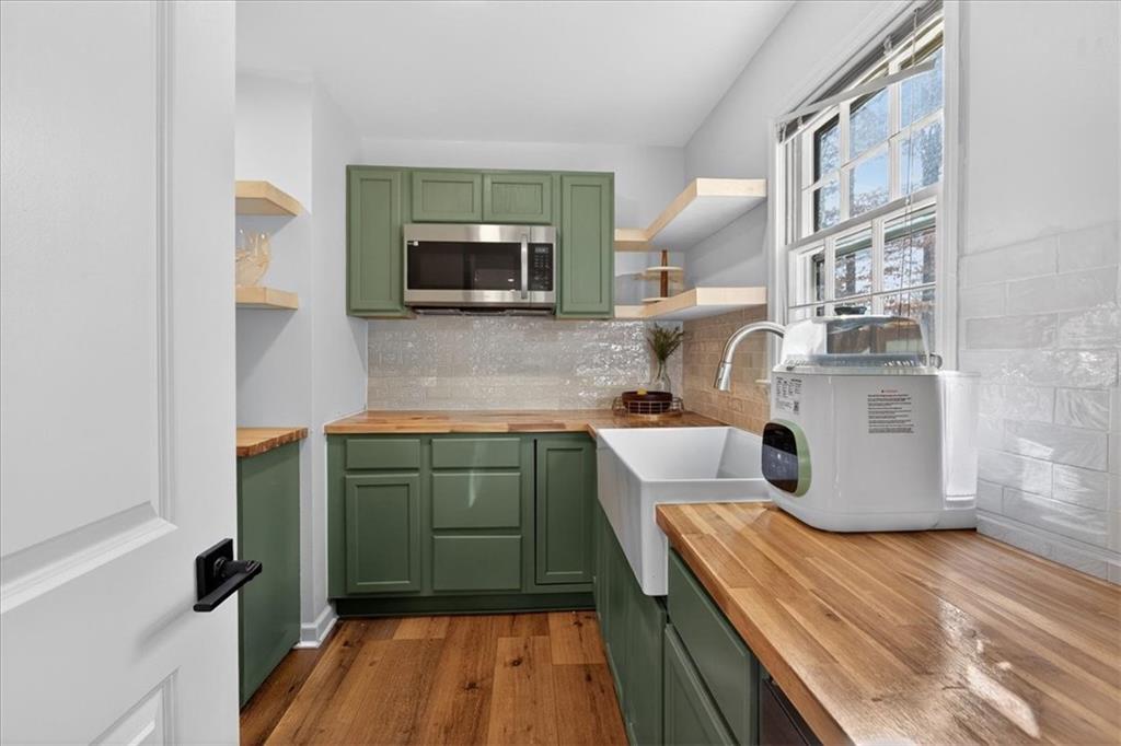 16145 Henderson Road Alpharetta, GA 30004 - Photo 24 of 61 a kitchen with a sink cabinets and microwave