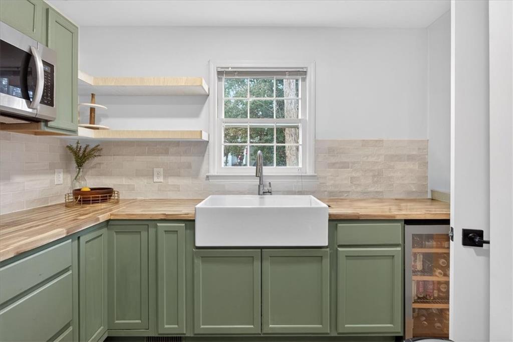 16145 Henderson Road Alpharetta, GA 30004 - Photo 25 of 61 a kitchen with a sink and cabinets