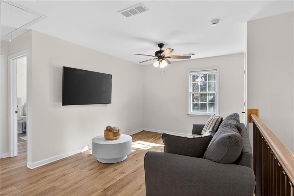16145 Henderson Road Alpharetta, GA 30004 - Photo 29 of 61 a living room with furniture and a flat screen tv