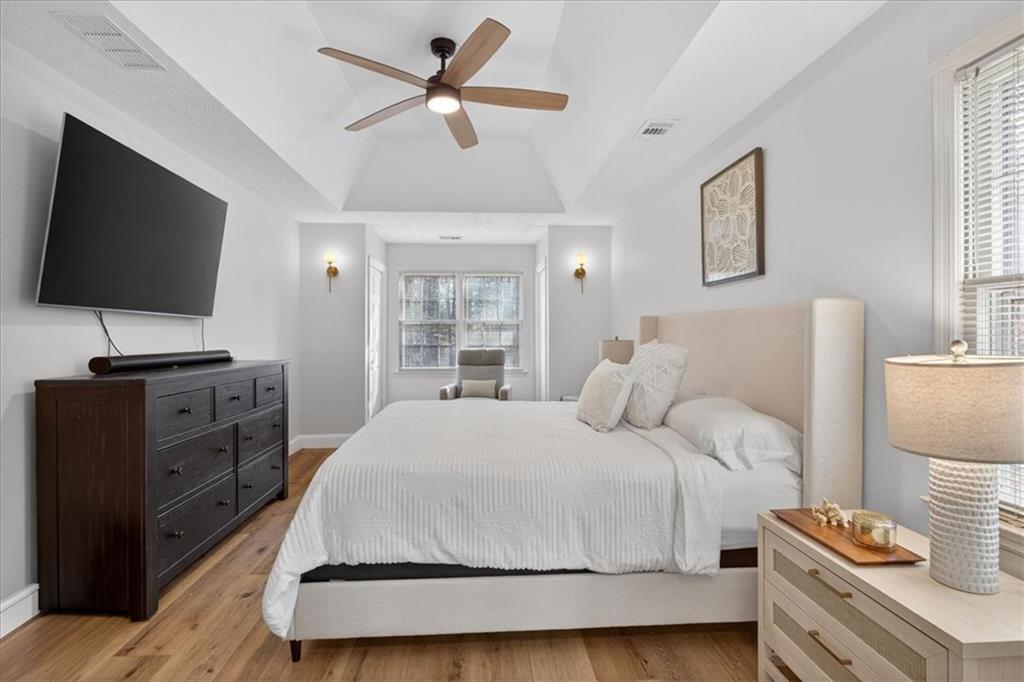 16145 Henderson Road Alpharetta, GA 30004 - Photo 31 of 61 a bedroom with a bed and a flat screen tv