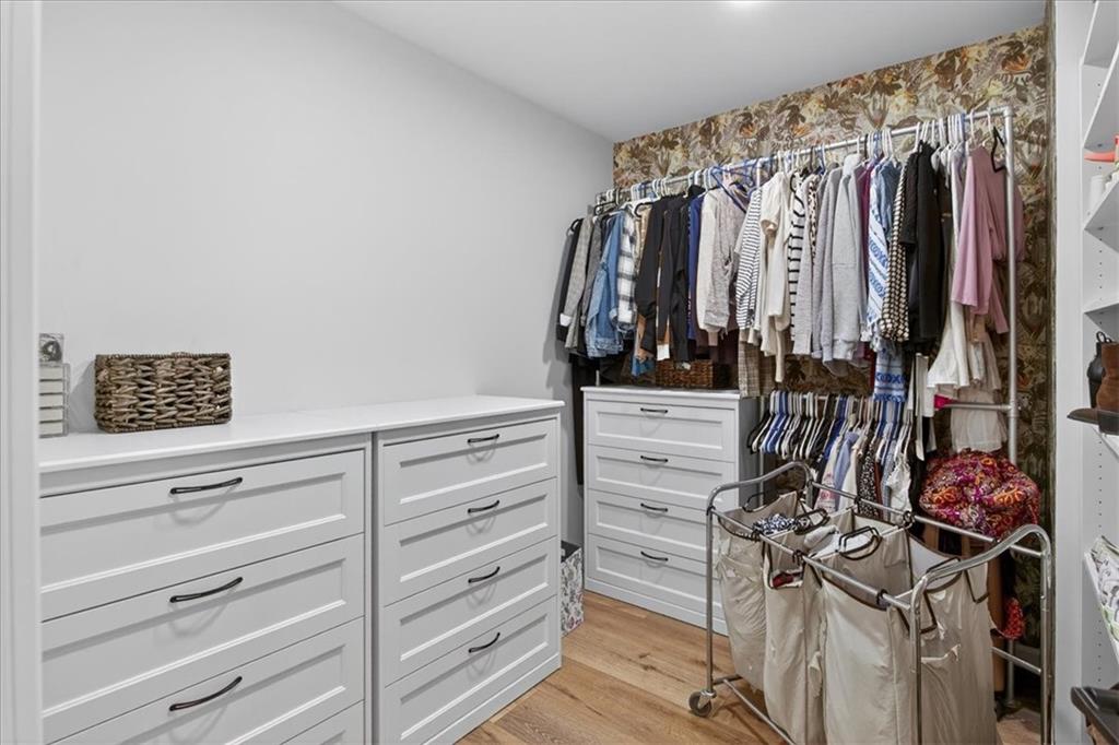 16145 Henderson Road Alpharetta, GA 30004 - Photo 32 of 61 a view of walk in closet with clothes
