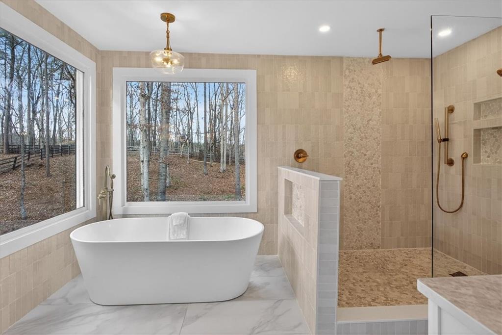16145 Henderson Road Alpharetta, GA 30004 - Photo 33 of 61 a bathroom with a bathtub and shower