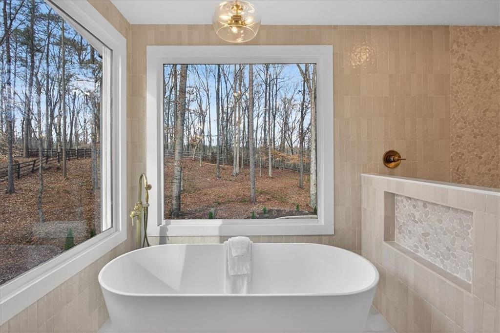16145 Henderson Road Alpharetta, GA 30004 - Photo 34 of 61 a bathroom with shower and bathtub