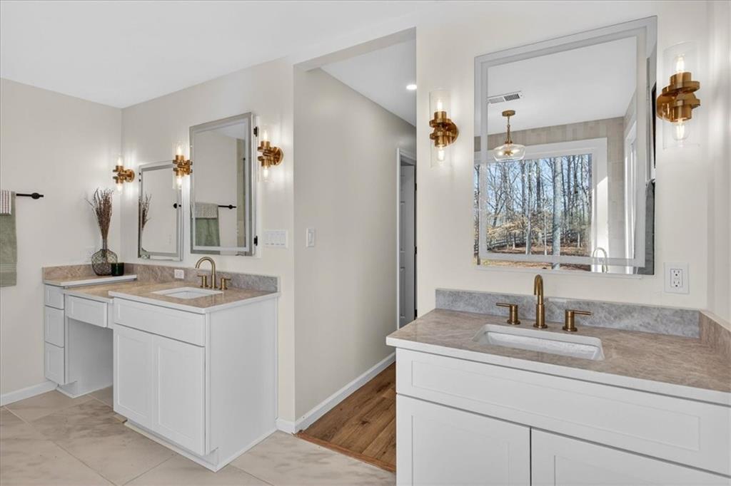 16145 Henderson Road Alpharetta, GA 30004 - Photo 36 of 61 a bathroom with a sink and a mirror