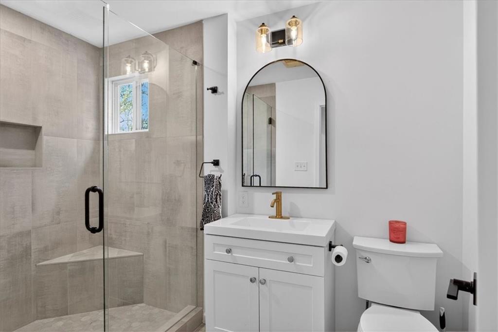 16145 Henderson Road Alpharetta, GA 30004 - Photo 38 of 61 a bathroom with a sink toilet and shower