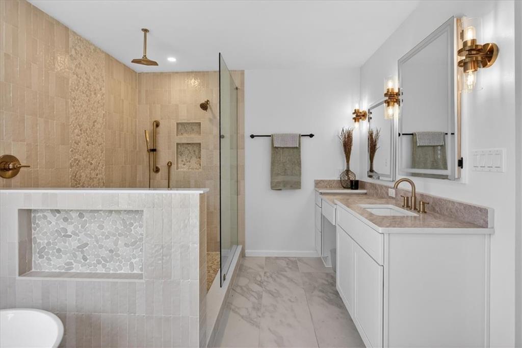 16145 Henderson Road Alpharetta, GA 30004 - Photo 4 of 61 a bathroom with a granite countertop sink a mirror and a shower