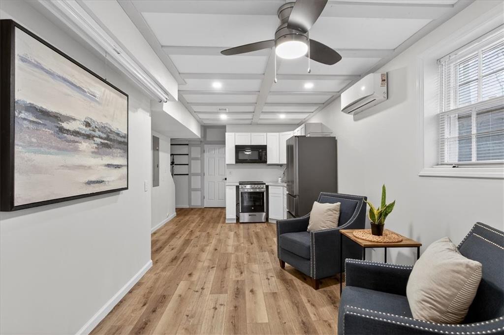 16145 Henderson Road Alpharetta, GA 30004 - Photo 46 of 61 a living room with furniture and a fireplace