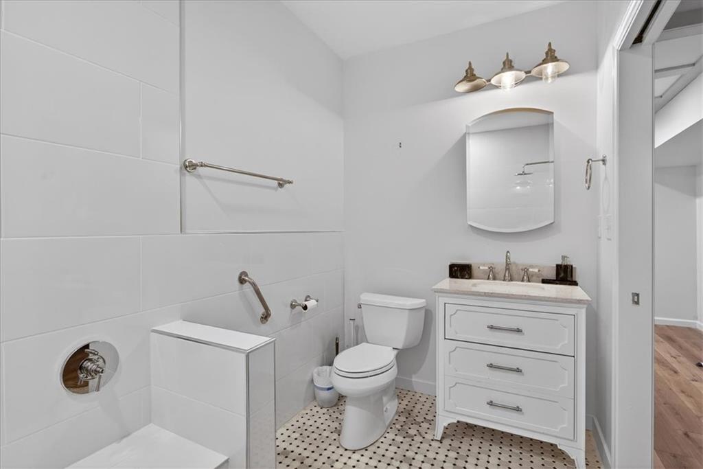 16145 Henderson Road Alpharetta, GA 30004 - Photo 47 of 61 a bathroom with a toilet sink vanity and mirror