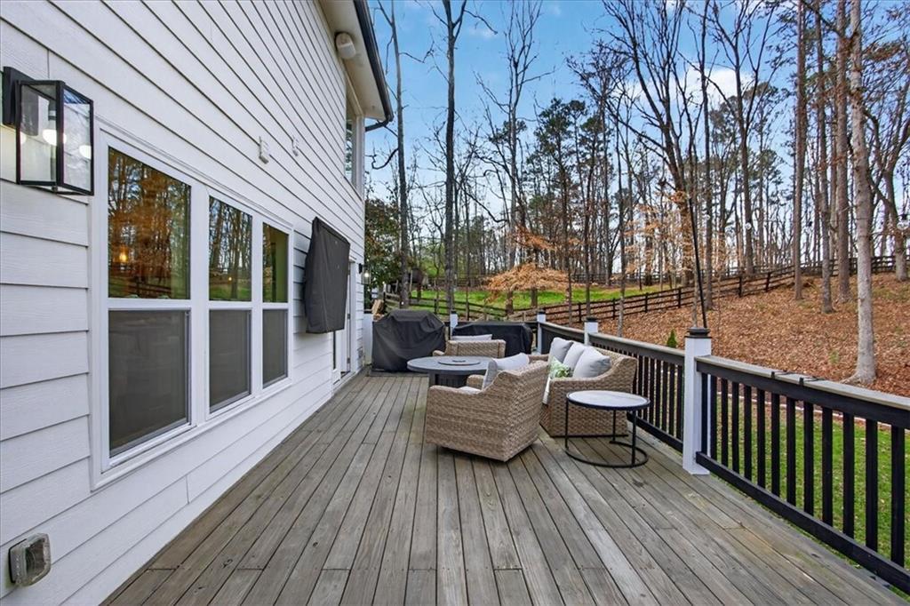 16145 Henderson Road Alpharetta, GA 30004 - Photo 50 of 61 a view of house with deck outdoor seating and wooden floor