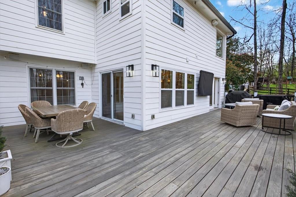 16145 Henderson Road Alpharetta, GA 30004 - Photo 51 of 61 a view of a patio with table and chairs and wooden floor