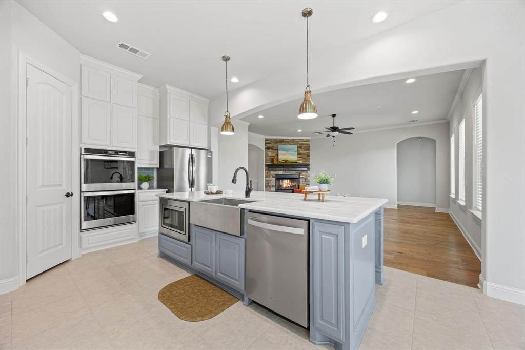 1109 Rendon Place Mansfield, TX 76063 - Photo 9 of 33 a kitchen with stainless steel appliances kitchen island granite countertop a sink and cabinets