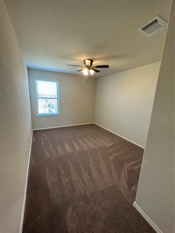 148 Prairie Falcon Way Leander, TX 78641 - Photo 7 of 19 an empty room with windows and fan