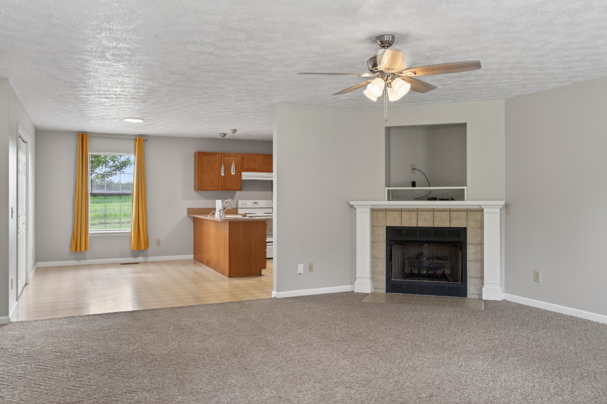 618 Lear Road Portland, TN 37148 - Photo 8 of 29 a view of a livingroom with a fireplace cabinet and a chandelier