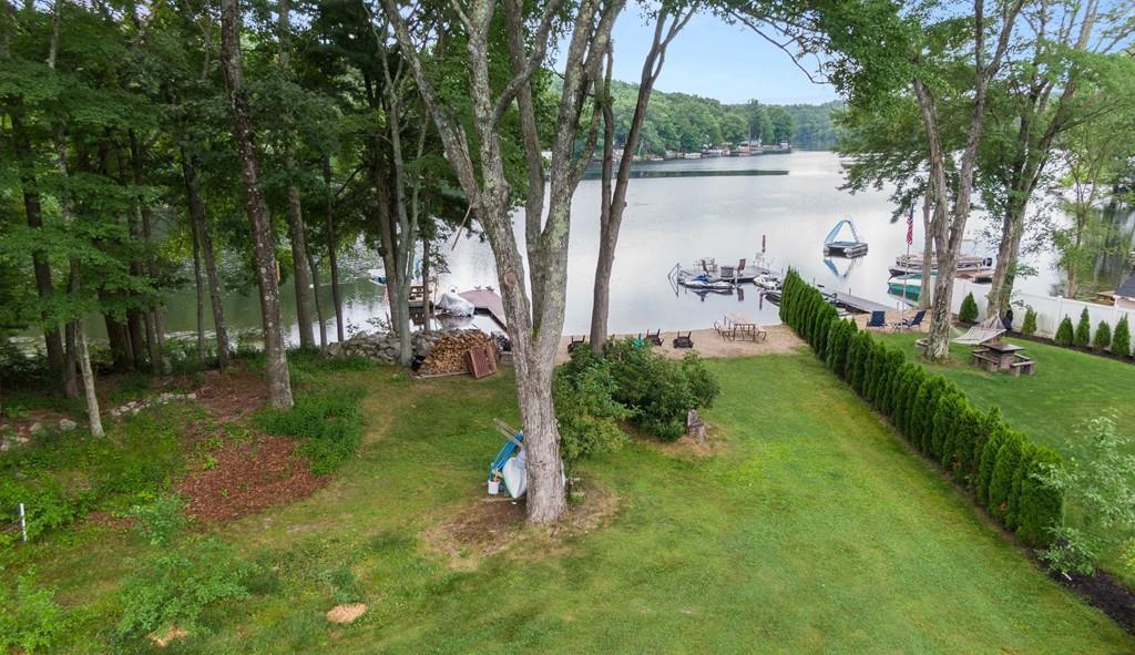 a view of a water pond with green yard