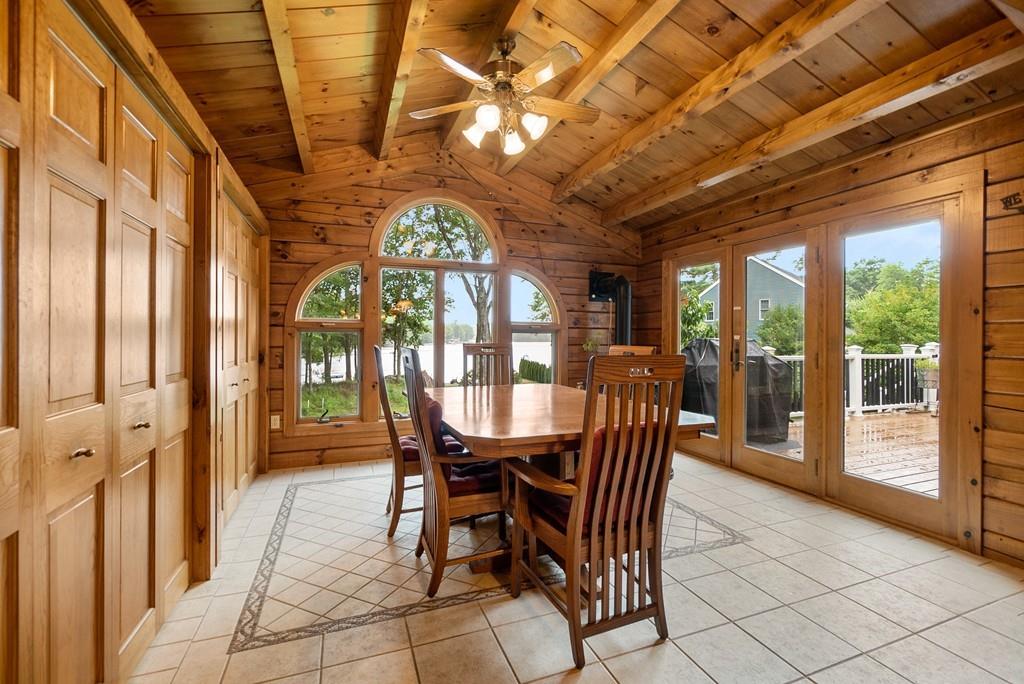 24 Ridge Trail Douglas, MA 01516 - Photo 14 of 36 a view of a dining room with furniture large windows and wooden floor