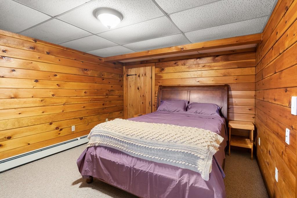 24 Ridge Trail Douglas, MA 01516 - Photo 25 of 36 a bedroom with a bed and wooden floor