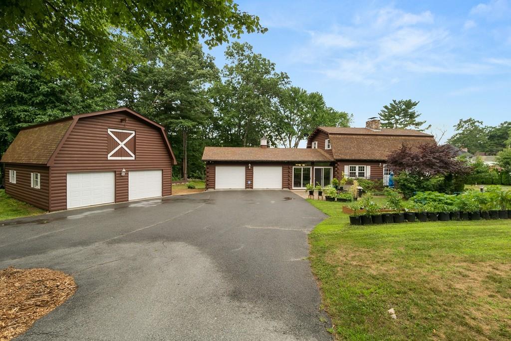 24 Ridge Trail Douglas, MA 01516 - Photo 6 of 36 a front view of a house with garden