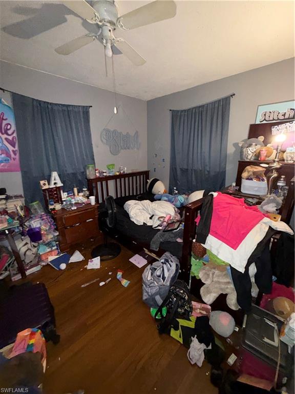 117 Robert Avenue Lehigh Acres, FL 33936 - Photo 12 of 20 Bedroom featuring a ceiling fan and dark wood-style floors