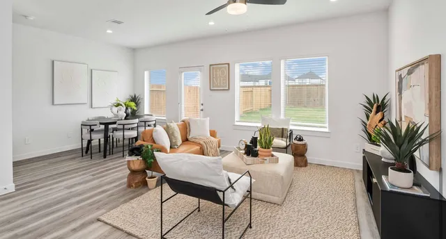 a dining room with furniture window and wooden floor