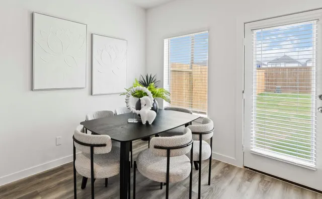 a view of a dining room with furniture and wooden floor