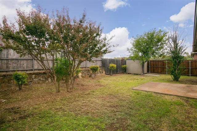 a view of backyard of house with green space