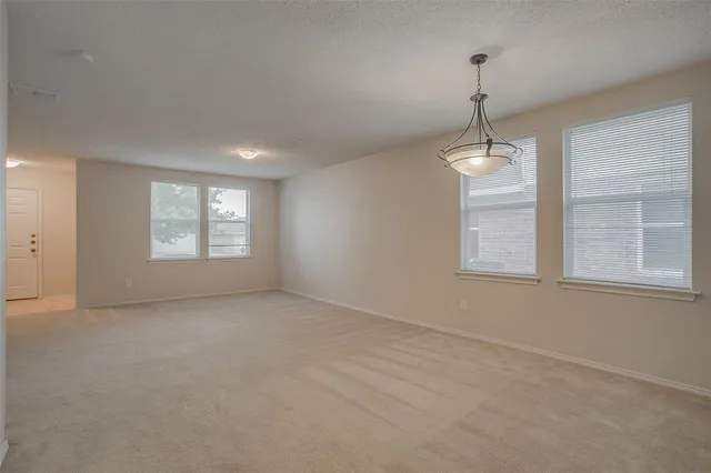 a view of an empty room with windows