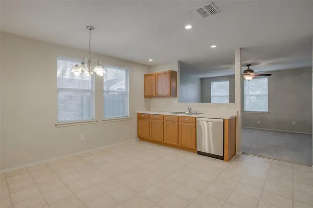 a large kitchen with kitchen island a sink stainless steel appliances and cabinets