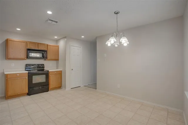 a kitchen with stainless steel appliances a refrigerator sink and stove