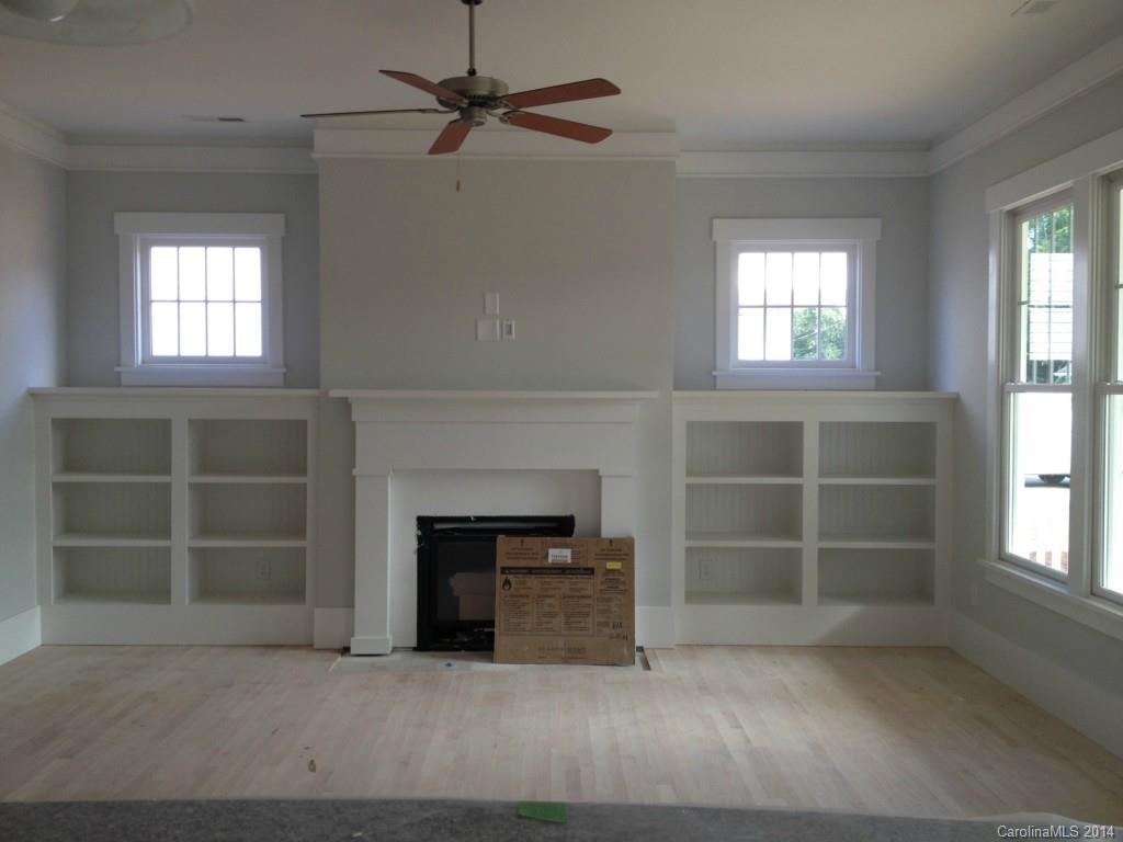529 Marsh Road Charlotte, NC 28209 - Photo 4 of 13 an empty room with a fireplace and windows