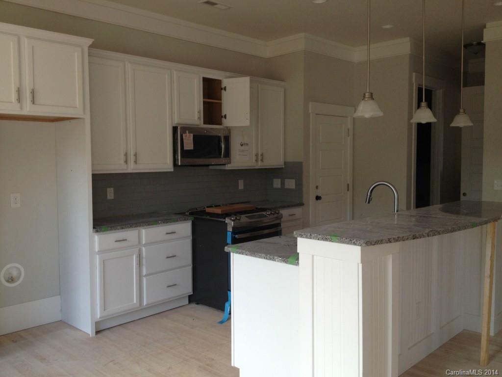 529 Marsh Road Charlotte, NC 28209 - Photo 5 of 13 a kitchen with stainless steel appliances granite countertop a stove a sink and a microwave