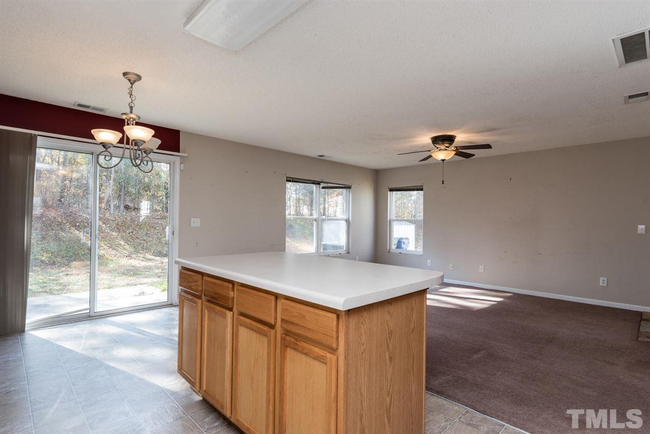 3670 Marshlane Way Raleigh, NC 27610 - Photo 12 of 22 a kitchen with a wooden floor and a window