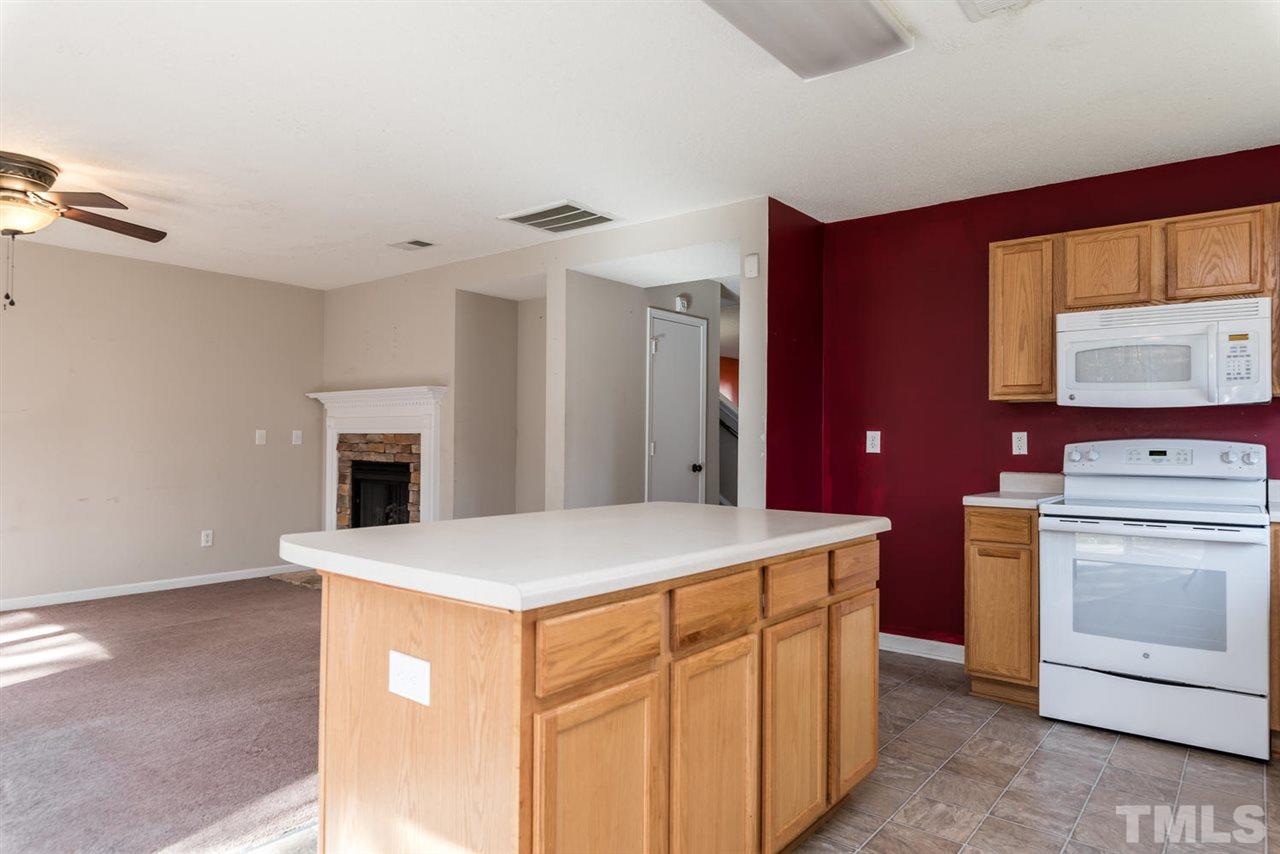 3670 Marshlane Way Raleigh, NC 27610 - Photo 13 of 22 a kitchen with a stove and a refrigerator