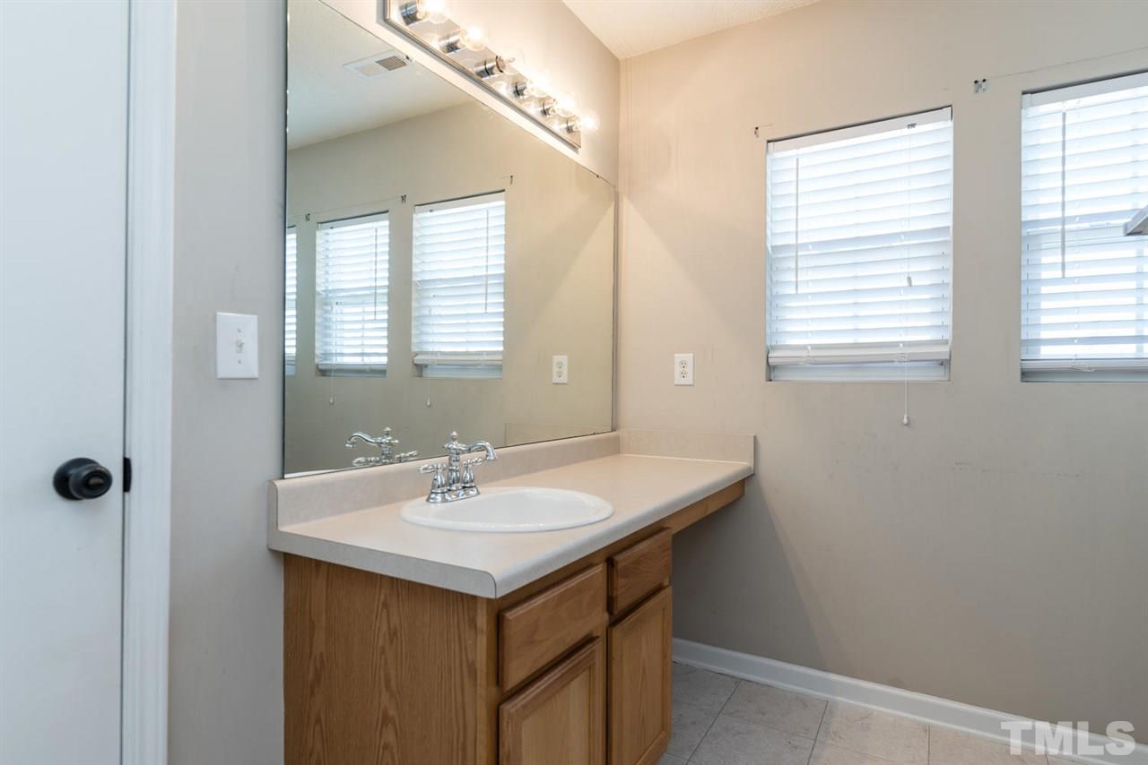 3670 Marshlane Way Raleigh, NC 27610 - Photo 17 of 22 a bathroom with a sink and a mirror