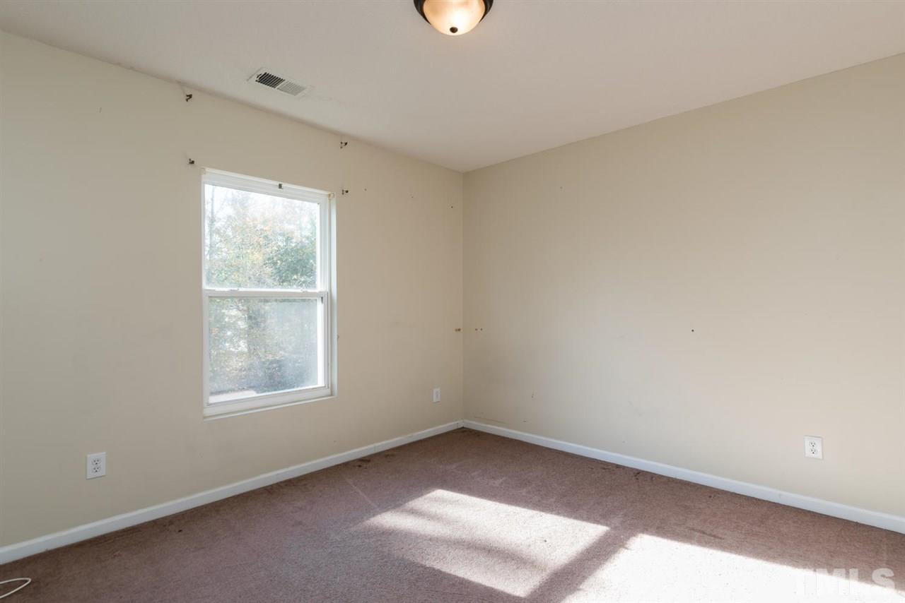 3670 Marshlane Way Raleigh, NC 27610 - Photo 18 of 22 an empty room with a window