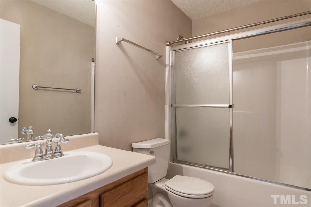 3670 Marshlane Way Raleigh, NC 27610 - Photo 19 of 22 a bathroom with a sink toilet and shower