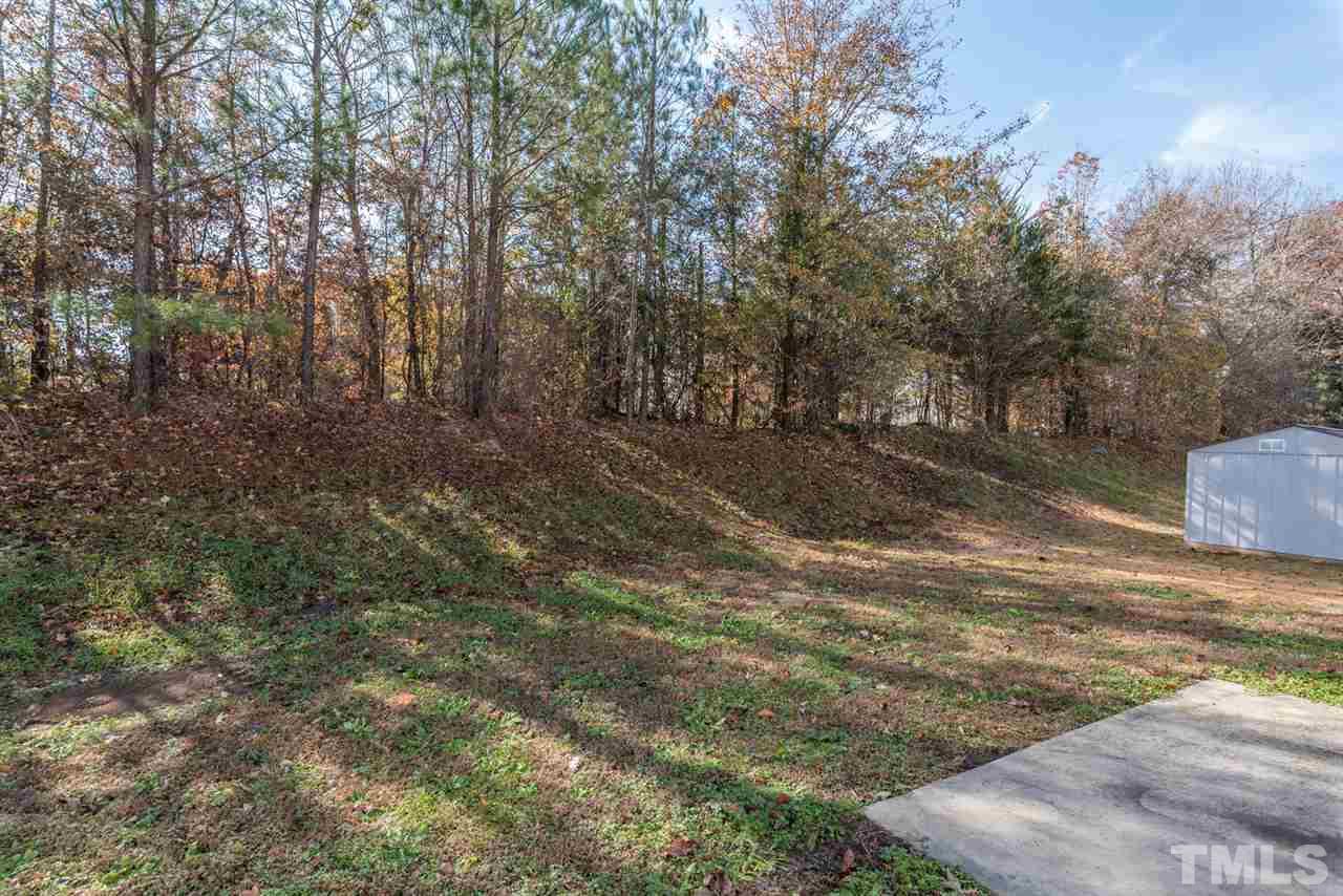 3670 Marshlane Way Raleigh, NC 27610 - Photo 22 of 22 a view of a yard with plants and trees