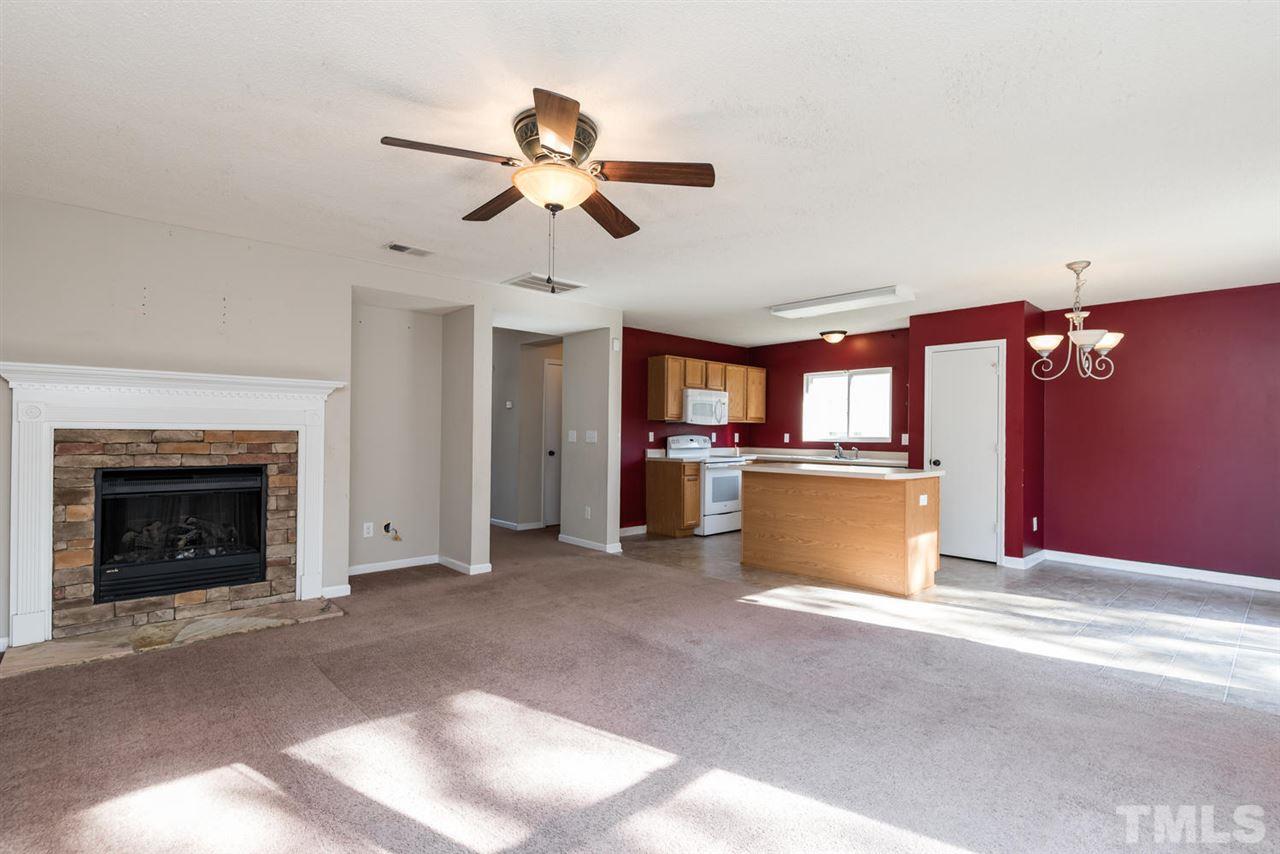 3670 Marshlane Way Raleigh, NC 27610 - Photo 7 of 22 a view of an empty room with a fireplace