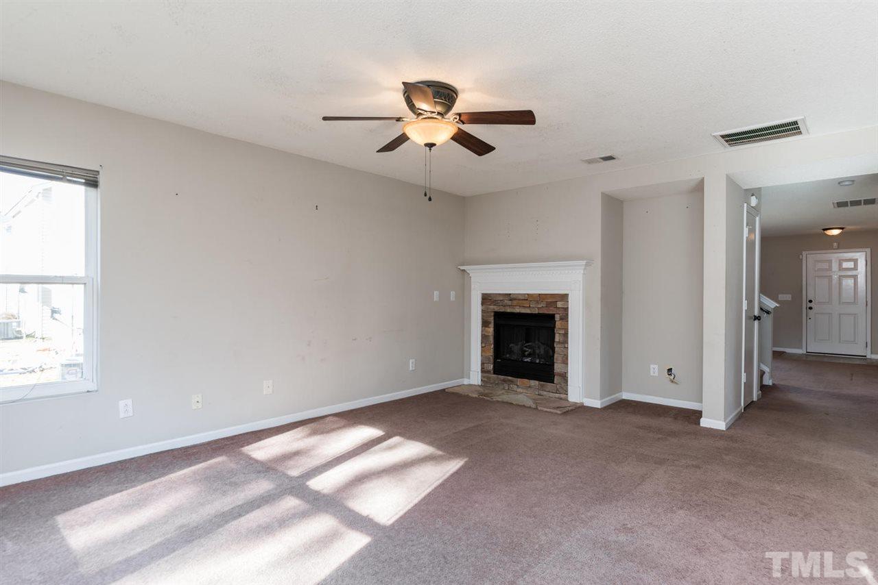 3670 Marshlane Way Raleigh, NC 27610 - Photo 9 of 22 wooden floor in an empty room with a window