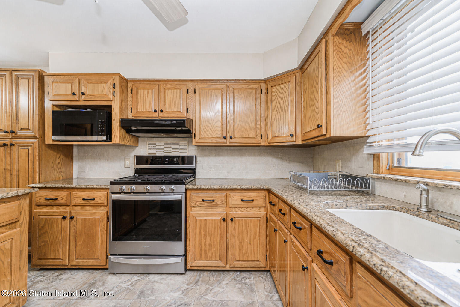 471 Main Street Staten Island, NY 10307 - Photo 15 of 39 a kitchen with stainless steel appliances granite countertop a stove sink microwave and refrigerator