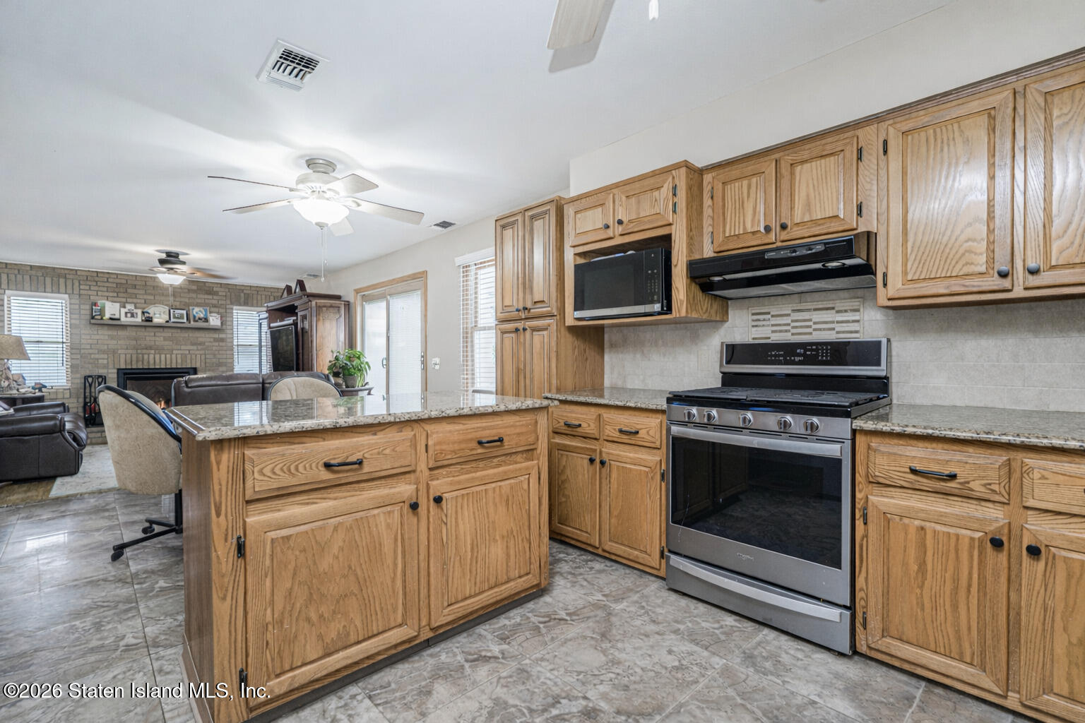 471 Main Street Staten Island, NY 10307 - Photo 16 of 39 a kitchen with stainless steel appliances granite countertop a stove microwave and cabinets