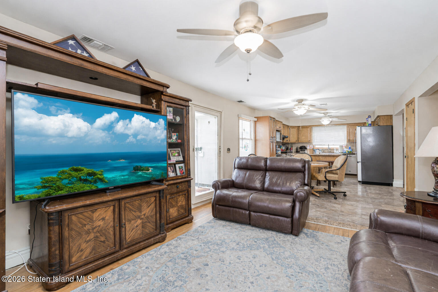 471 Main Street Staten Island, NY 10307 - Photo 17 of 39 a living room with furniture a flat screen tv and a floor to ceiling window