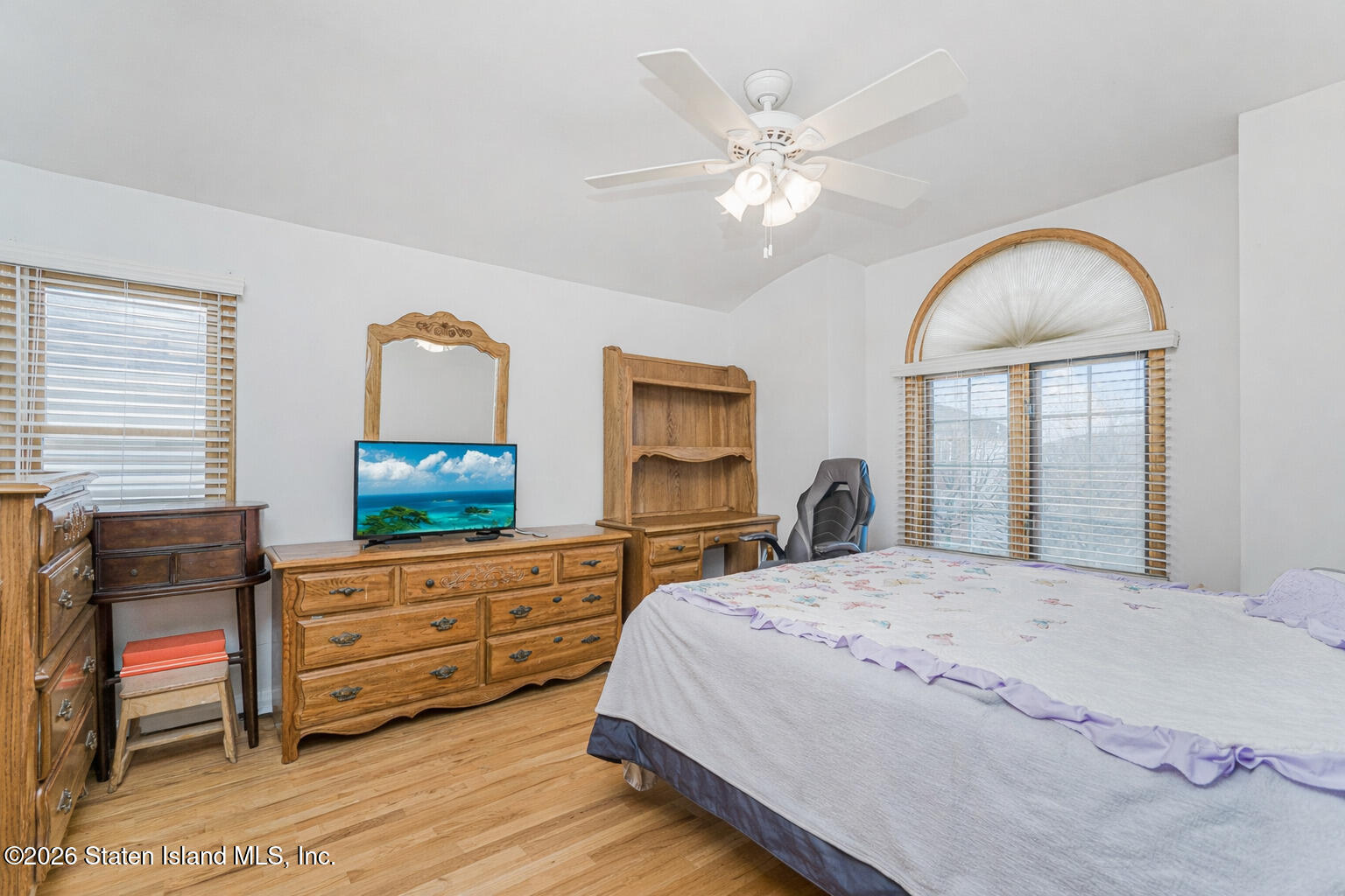 471 Main Street Staten Island, NY 10307 - Photo 23 of 39 a bedroom with a bed and a dresser with mirror