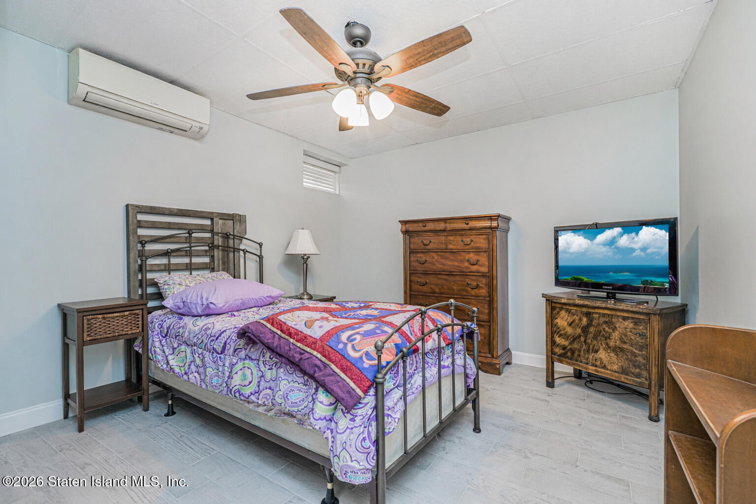 471 Main Street Staten Island, NY 10307 - Photo 30 of 39 a bedroom with a bed and a flat tv screen on dresser
