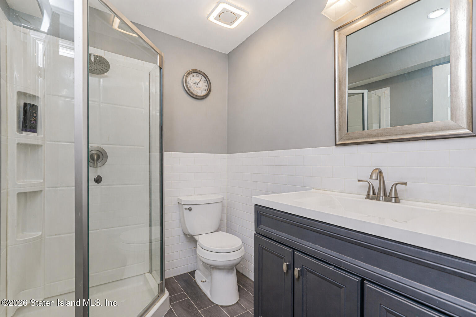 471 Main Street Staten Island, NY 10307 - Photo 31 of 39 a bathroom with a sink a toilet and a mirror