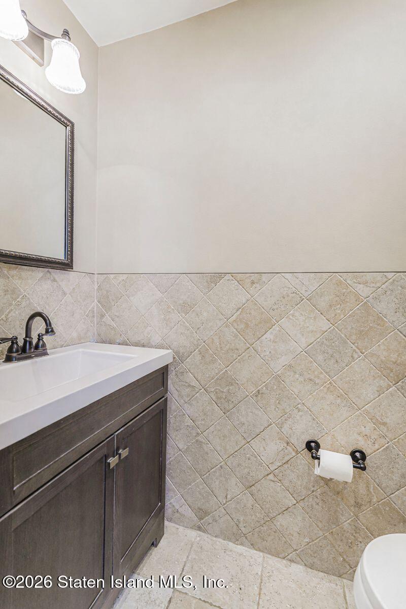 471 Main Street Staten Island, NY 10307 - Photo 10 of 39 a bathroom with a sink a toilet and mirror