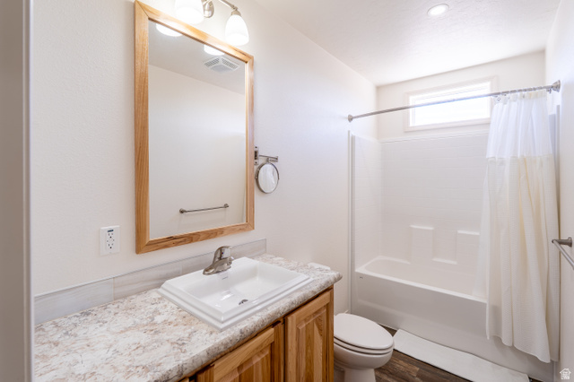 700 East Peter Springs Road Monticello, UT 84535 - Photo 30 of 57 Bathroom featuring a single vanity with a laminate countertop, a rectangular drop-in sink, and a wood-finish cabinet