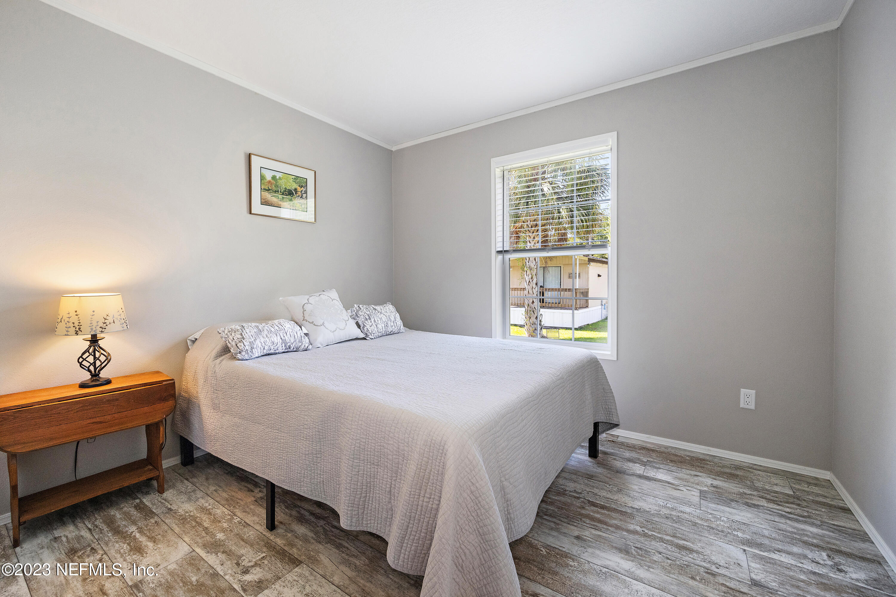 117 Riverside Avenue Satsuma, FL 32189 - Photo 13 of 24 a bedroom with bed and window