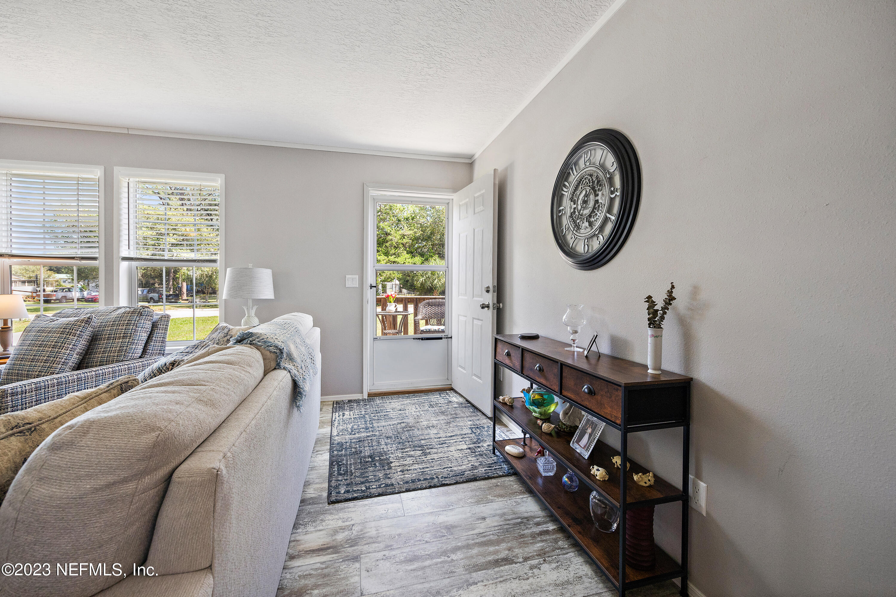 117 Riverside Avenue Satsuma, FL 32189 - Photo 18 of 24 a living room with furniture a window and a clock