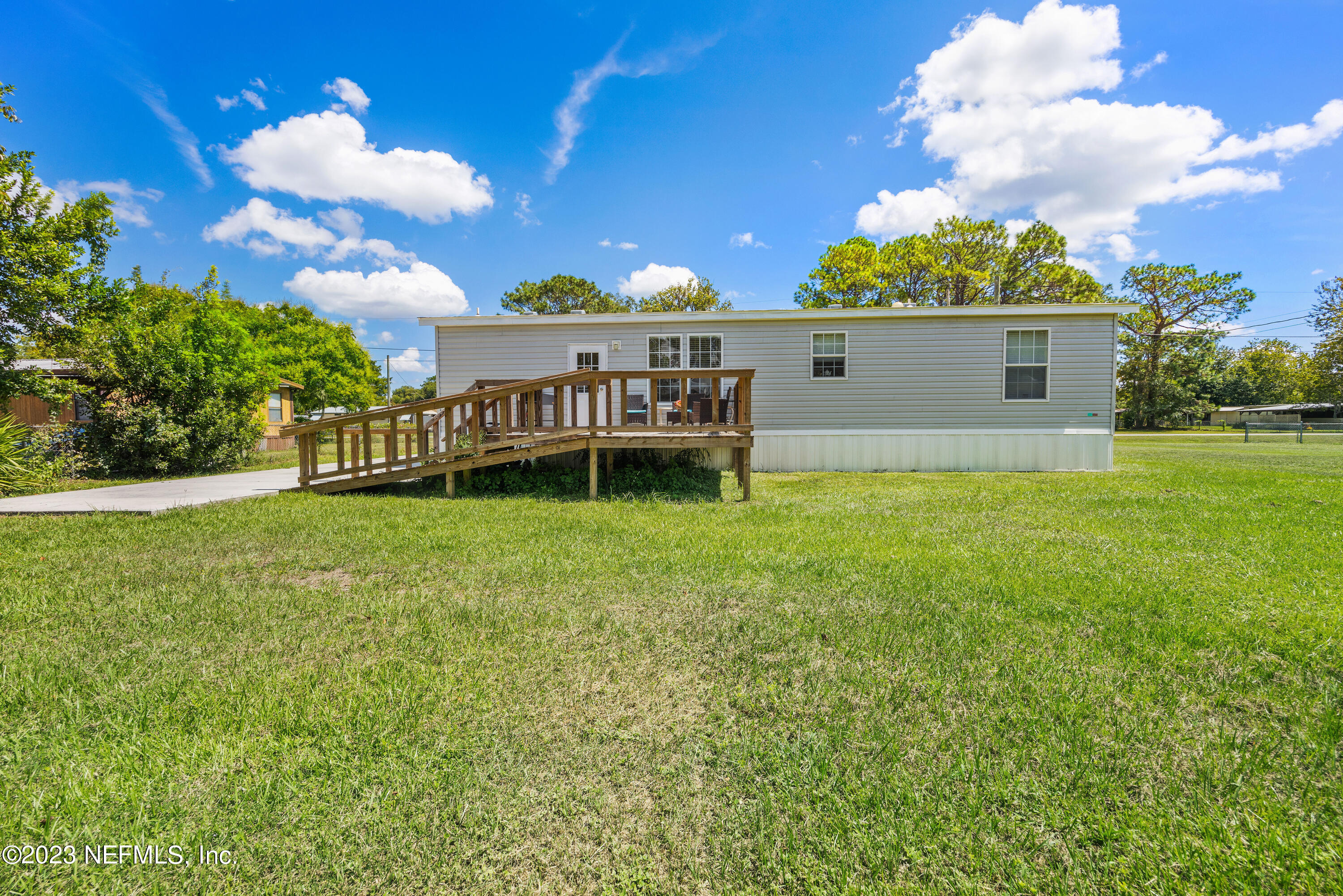 117 Riverside Avenue Satsuma, FL 32189 - Photo 20 of 24 a view of a house with a backyard and a patio