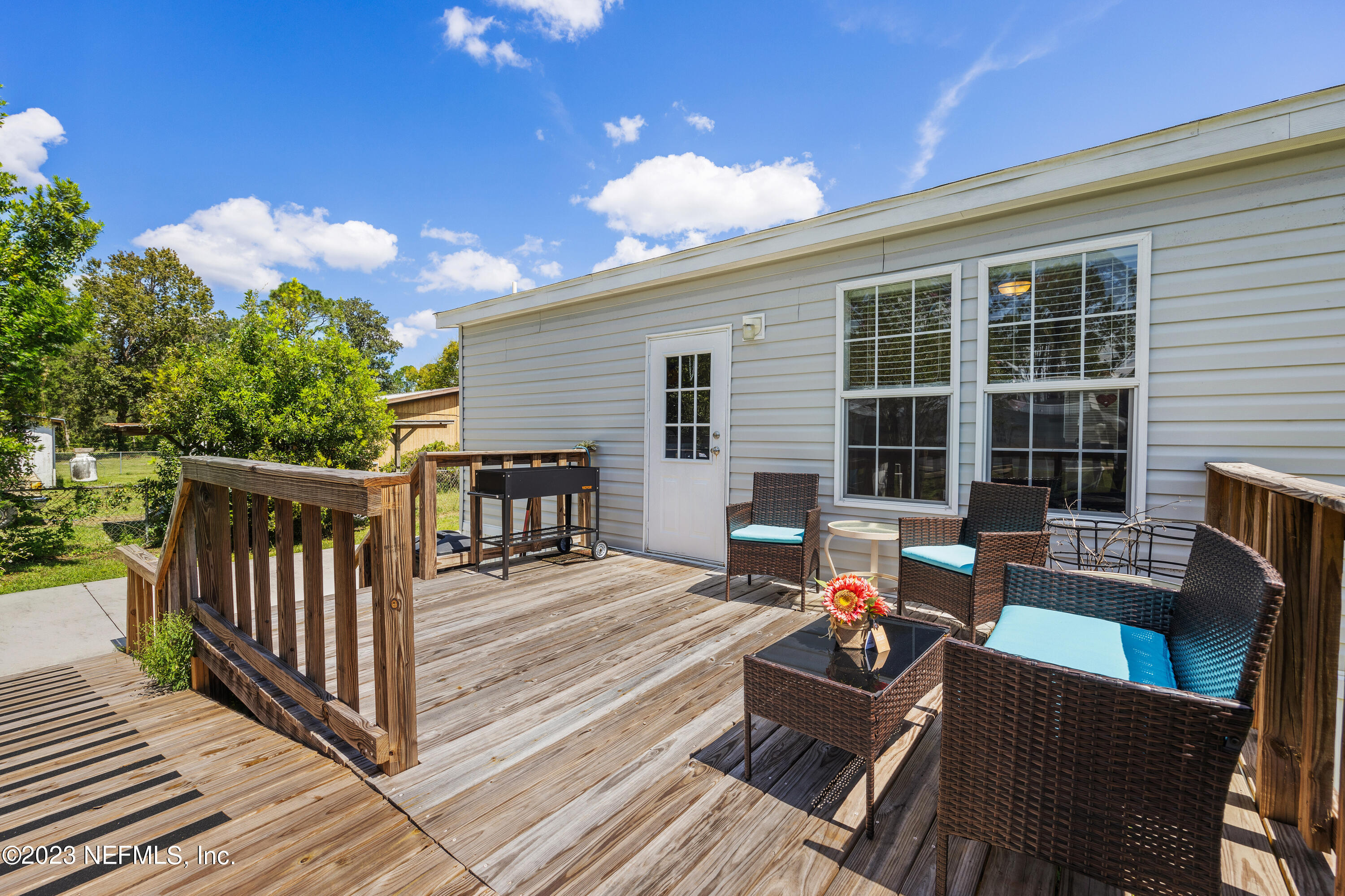 117 Riverside Avenue Satsuma, FL 32189 - Photo 21 of 24 a view of a two chairs in the deck